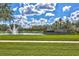 Grand Hampton entrance with water feature and lush landscaping at 7938 Hampton Lake Dr, Tampa, FL 33647