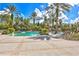 Relaxing pool area with palm trees, lounge chairs, and water features at 7938 Hampton Lake Dr, Tampa, FL 33647