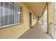 Building hallway with light yellow walls and individual condo entrances at 3753 Lake Bayshore Dr # H305, Bradenton, FL 34205