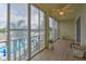 Screened lanai with wood-look flooring and serene water views at 3753 Lake Bayshore Dr # H305, Bradenton, FL 34205