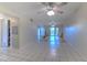 Open living room with tiled floors and ceiling fan at 3753 Lake Bayshore Dr # H305, Bradenton, FL 34205