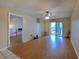 Living room with wood-look flooring and access to balcony at 3753 Lake Bayshore Dr # H305, Bradenton, FL 34205