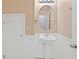 Simple bathroom with pedestal sink and oval mirror at 37658 Aaralyn Rd, Zephyrhills, FL 33542