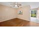 Dining area with wood floors, pass-through kitchen window, and sliding doors to patio at 37658 Aaralyn Rd, Zephyrhills, FL 33542