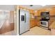 Kitchen features stainless steel refrigerator and wood cabinets at 37658 Aaralyn Rd, Zephyrhills, FL 33542