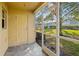 Screened porch overlooking backyard with green space at 37658 Aaralyn Rd, Zephyrhills, FL 33542