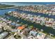 Wide aerial showcasing home's waterfront location and neighborhood at 909 Birdie Way, Apollo Beach, FL 33572