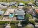 Aerial view of house with pool, dock and canal views at 909 Birdie Way, Apollo Beach, FL 33572