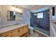 Bathroom with a walk-in shower, marble vanity, and subway tile at 909 Birdie Way, Apollo Beach, FL 33572