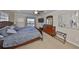 Main bedroom with king bed, water view, and built-in dresser at 909 Birdie Way, Apollo Beach, FL 33572