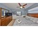 Guest bedroom with a queen bed, TV, and window with water views at 909 Birdie Way, Apollo Beach, FL 33572