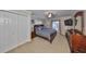 Main bedroom with a king-size bed, dresser, and large closet at 909 Birdie Way, Apollo Beach, FL 33572