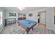 Game room with pool table, hardwood floors, and bar at 909 Birdie Way, Apollo Beach, FL 33572