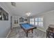 Game room with pool table and hardwood floors at 909 Birdie Way, Apollo Beach, FL 33572