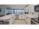 Modern kitchen with white cabinets, quartz countertops, and stainless steel appliances at 909 Birdie Way, Apollo Beach, FL 33572