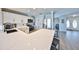Modern kitchen with white cabinets and expansive quartz countertops at 909 Birdie Way, Apollo Beach, FL 33572