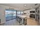 Modern kitchen boasts water views, breakfast bar, and stainless steel appliances at 909 Birdie Way, Apollo Beach, FL 33572