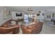 Spacious living room with leather sofas and a view of the pool and kitchen at 909 Birdie Way, Apollo Beach, FL 33572