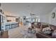 Open living area with kitchen, leather couches, and pool table at 909 Birdie Way, Apollo Beach, FL 33572