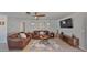 Living area with brown couches, coffee table, and large TV at 909 Birdie Way, Apollo Beach, FL 33572