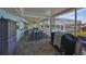 Covered patio with outdoor kitchen and seating at 909 Birdie Way, Apollo Beach, FL 33572