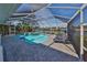 Relaxing pool and spa with covered patio and lounge chairs at 909 Birdie Way, Apollo Beach, FL 33572