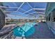 Relaxing pool area with spa and screened enclosure at 909 Birdie Way, Apollo Beach, FL 33572