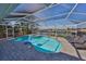 Inviting kidney-shaped pool with a screened enclosure at 909 Birdie Way, Apollo Beach, FL 33572
