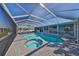 Large screened-in pool and spa with patio furniture at 909 Birdie Way, Apollo Beach, FL 33572