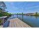 Wooden dock offers scenic canal views and a relaxing setting at 909 Birdie Way, Apollo Beach, FL 33572