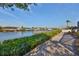 Scenic waterfront view with lush vegetation and private dock access at 909 Birdie Way, Apollo Beach, FL 33572