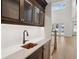Stylish bar area with custom cabinets, a copper sink, and a wine refrigerator at 4010 W Watrous Ave, Tampa, FL 33629