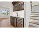 Elegant bar with custom cabinets, a copper sink, a wine refrigerator, and hardwood steps at 4010 W Watrous Ave, Tampa, FL 33629