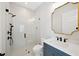 Bright bathroom showcasing a glass shower, a vanity with a marble countertop and a gold framed mirror at 4010 W Watrous Ave, Tampa, FL 33629