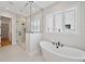 Luxurious bathroom featuring a soaking tub and large walk-in shower with decorative tile at 4010 W Watrous Ave, Tampa, FL 33629