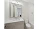 Bathroom featuring white cabinets, subway tile, and a square mirror above the sink at 4010 W Watrous Ave, Tampa, FL 33629
