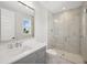 Bright bathroom with dual sinks and a glass enclosed shower with marble surround at 4010 W Watrous Ave, Tampa, FL 33629