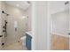 Modern bathroom featuring a glass shower, blue vanity, and stylish geometric floor tiles at 4010 W Watrous Ave, Tampa, FL 33629