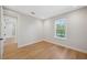 Bright bedroom with hardwood floors and large window with views of mature trees and a lake at 4010 W Watrous Ave, Tampa, FL 33629