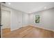 Bright bedroom with hardwood floors, white trim, and a window with a view at 4010 W Watrous Ave, Tampa, FL 33629