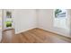 Light filled bedroom featuring hardwood floors, white walls and trim at 4010 W Watrous Ave, Tampa, FL 33629