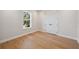 Bright bedroom with hardwood floors and a window with views of mature trees at 4010 W Watrous Ave, Tampa, FL 33629