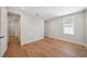 Bright bedroom with hardwood floors, white trim, and open access to a hallway at 4010 W Watrous Ave, Tampa, FL 33629