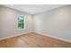 Bright bedroom with hardwood floors and a window with views of mature trees at 4010 W Watrous Ave, Tampa, FL 33629
