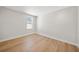 Bedroom with hardwood floors, white trim, and a window allowing natural light at 4010 W Watrous Ave, Tampa, FL 33629