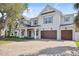 Beautiful two-story home featuring a brick driveway and a three car garage at 4010 W Watrous Ave, Tampa, FL 33629