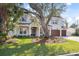 Charming home featuring a well-manicured lawn, mature trees, and a three-car garage at 4010 W Watrous Ave, Tampa, FL 33629