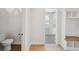 Bright hallway with a view of a powder room, a mudroom and hardwood floors at 4010 W Watrous Ave, Tampa, FL 33629