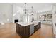 Kitchen island with sink and dishwasher overlooks the living room with fireplace at 4010 W Watrous Ave, Tampa, FL 33629