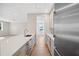 Bright kitchen with stainless steel appliances, white cabinets, quartz countertops, and hardwood floors at 4010 W Watrous Ave, Tampa, FL 33629